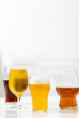 Glasses  light and dark beer on light surface food and drink copy space