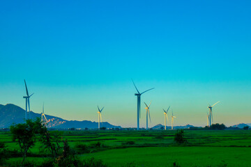 Landscape with Turbine Green Energy Electricity, Windmill for electric power production, Wind turbines generating electricity on rice field at Phan Rang, Ninh Thuan, Vietnam. Clean energy concept.