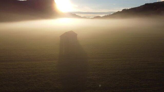 Aerial shot of a foggy landscape under the bright sun in More og Romsdal, Norway