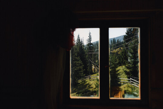 View from the house in the forest. Window with a beautiful view on the mountain's . Vacation home for the rest near the forest.