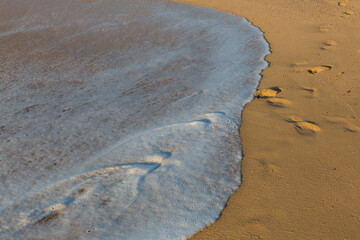 .Small waves reaching the fine sand beach