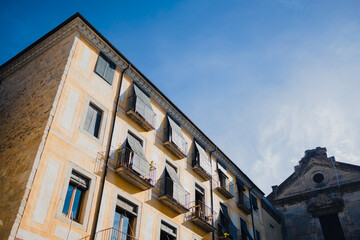 Fototapeta na wymiar traditional spanish architecture in the small streets of old town Girona in Catalonia on a sunny day
