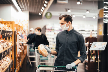 close up. young man buying bread in a supermarket.