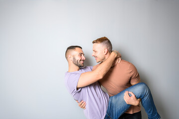 Two young men couple over white background on studio