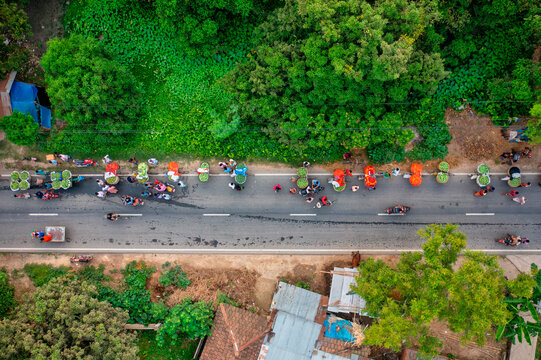 Aerial view of people with bikes transporting fruits, Bandarban, Bangladesh.