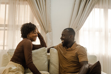 A black couple smiling at each other