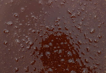 Texture surface of liquid dark bee honey with air bubbles. Autumn agricultural fair.