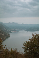 Fototapeta premium medieval town view to Loreto Island with the castle on Lake Iseo in Northern Italy - Stories vertical format and wallpaper, near Brescia and Bergamo cities in autumn