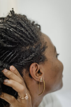 Black Woman Braiding Her Hair