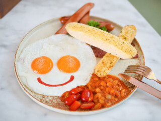 Breakfast. Happy Breakfast with sunny side up fried eggs peppers on top and ketchup smiling at you. Top view food photography.