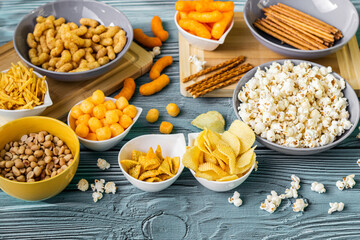Beer salty snacks on wooden table