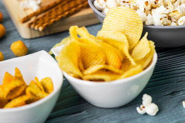 Beer salty snacks on wooden table