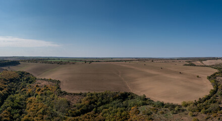 Fototapeta na wymiar drone view of endless brown plowed agricultural fields on the Danubian Plain of Bulgaria