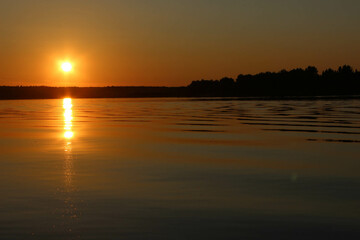 Beautiful sunset reflected in the water on a huge lake