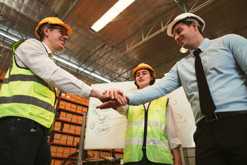 Group of Asian industrial worker has conclusion finished their work and joining hand or hand stack together for unity to the goal of business success with happiness. View from low angle.