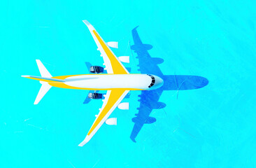 Fototapeta na wymiar Toy plane flies over a blue background