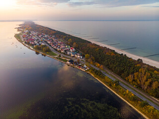 drone view of colourful autumn sunset over the village by the baltic sea, chalupy, poland;...