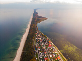 drone view of colourful autumn sunset over the village by the baltic sea, chalupy, poland;...