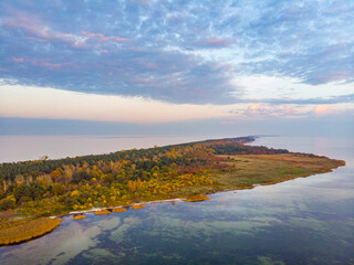 Fototapeta na wymiar drone view of a colourful autumn sunset over the hel peninsula, the baltic sea and the gulf of puck; colourful autumn leaves on the trees