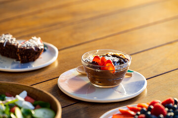 chocolate dessert with strawberries and coconut on a health food table