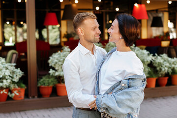 portrait of a romantic couple looking into each other's eyes on a walk