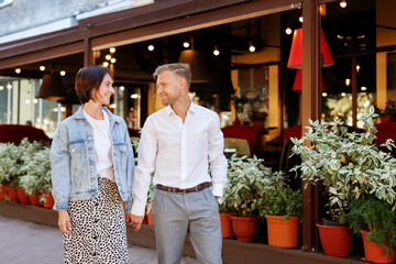 portrait of a romantic couple looking into each other's eyes on a walk around the city