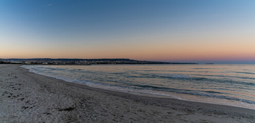 panorama landscape of Asparuhovo Beach at sunset and the Bulgarian Black Sea city of Varna in the background