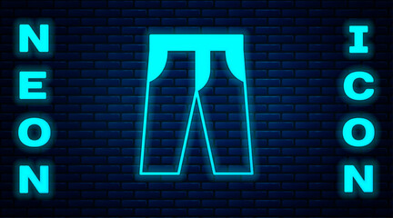 Glowing neon Pants icon isolated on brick wall background. Trousers sign. Vector
