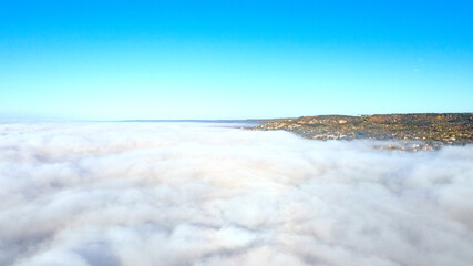 Fog clouds over the city, view from above