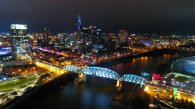 Aerial Panning Shot Of John Seigenthaler Pedestrian Bridge In City Against Clear Sky At Night - Nashville, Tennessee
