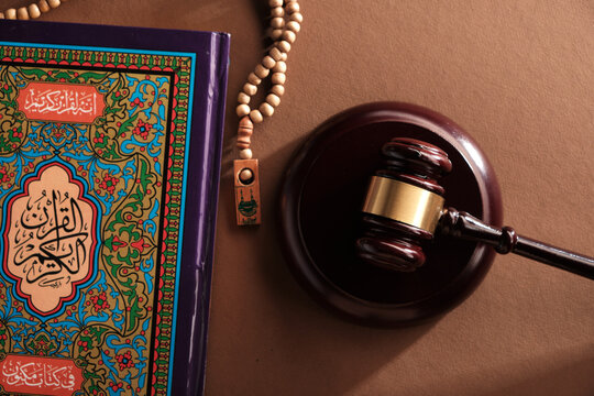 sharia law gavel hammer prayer beads and holy koran book