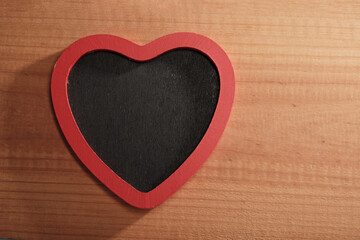 heart shape blackboard against wood background