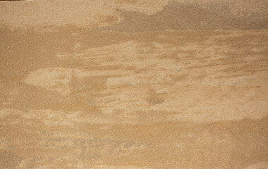 Obraz premium Brown background from decorative plaster with abstract spots. Unusual beige wall texture with beautiful patterns, creative surface background. Front covering for facing of buildings.