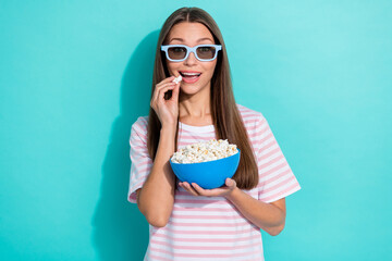 Portrait of girlish gorgeous woman long hairdo dressed striped t-shirt eat pop corn watch excited...