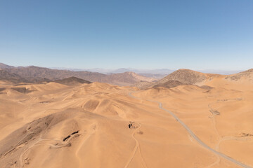 Fototapeta na wymiar Aerial view of mountains and a road in the atacama desert near the city of Copiapó