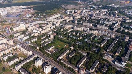 City, locality. Construction site, residential area on a sunny summer day. Apartment buildings, high-rise buildings. The view from the drone, from above.