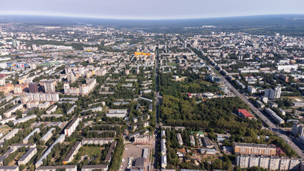Fototapeta premium City, locality. Construction site, residential area on a sunny summer day. Apartment buildings, high-rise buildings. The view from the drone, from above.
