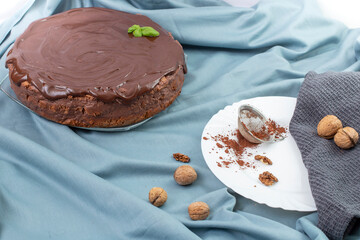 Round chocolate cake on blue fabric