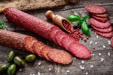 Best quality italian salami on old wooden table.