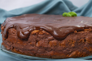 Round chocolate cake with dripping cocoa topping