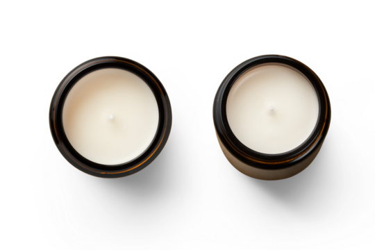 two unused white hand-poured soy wax scented candles in brown glass jars - isolated design elements for cozy or holiday scenes as well as self care themed designs, top view / flat lay