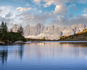 Calm autumn Alps mountain lake with clear transparent water and reflections. Spiegelsee or Mittersee or Mirror Lake, Reiteralm, Steiermark, Austria.