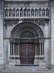 Monumental wooden door and gothic arch of St Pierre church, in Vaise (Lyon, France)