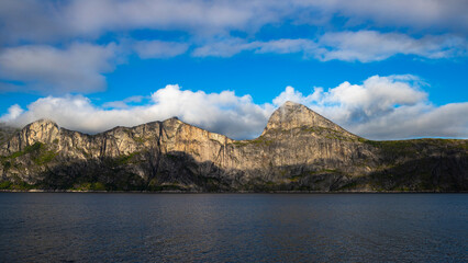 landscape of the island of senja in northern norway, mighty mountains and cliffs above the sea, fjords with breathtaking views