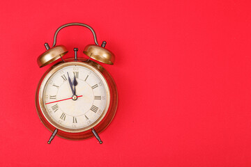 New Year's clock of gold color on a red background
