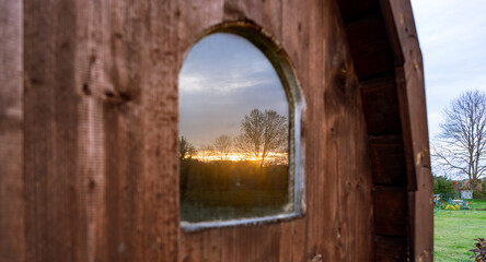 sunset reflection in the small sauna window