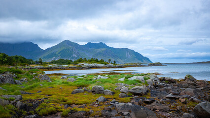 panorama of lofoten islands in northern norway; rugged norwegian fjords; mighty mountains hidden in the clouds, norwegian coastline