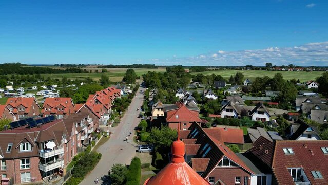 Along thin narrow lighthouse tower. Perfect aerial view flight island poel