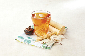 Bamboo Cane, Chuck Root and Horseshoe Sea Coconut Drink served in a cup isolated on napkin side...