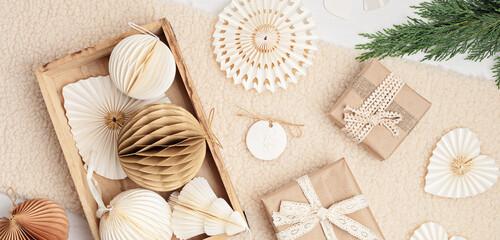Scandinavian christmas paper honeycomb ornaments in the box and gifts. Modern sustainable christmas...